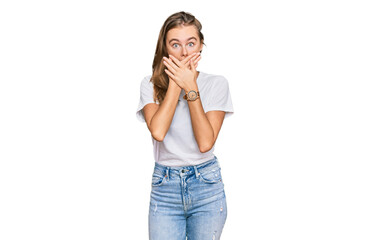 Beautiful young blonde woman wearing casual white t shirt shocked covering mouth with hands for mistake. secret concept.