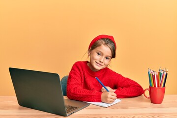 Little beautiful girl studying using computer laptop winking looking at the camera with sexy...