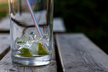 An empty glass on a table in a pub garden in England post-lockdown