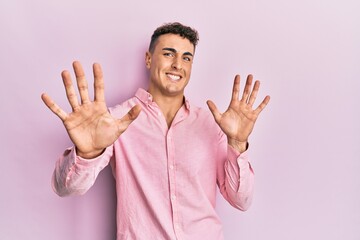 Hispanic young man wearing casual clothes afraid and terrified with fear expression stop gesture with hands, shouting in shock. panic concept.