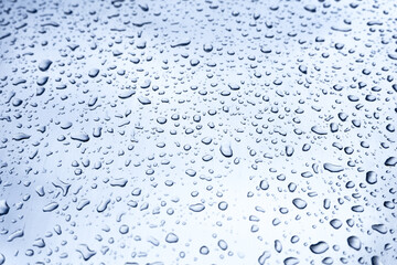 Many different drops of water on the metal surface