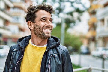 Handsome hispanic man with beard smiling happy outdoors