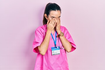 Young brunette woman wearing doctor uniform and stethoscope rubbing eyes for fatigue and headache, sleepy and tired expression. vision problem