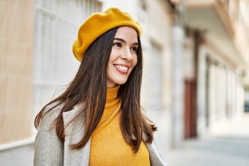 Young hispanic girl smiling happy standing at the city.