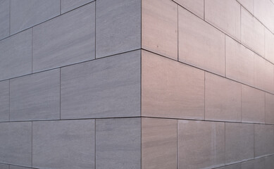 Abstract background of an office building made of stone and evening lights.