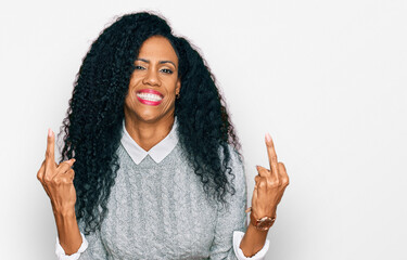 Middle age african american woman wearing casual clothes showing middle finger doing fuck you bad...