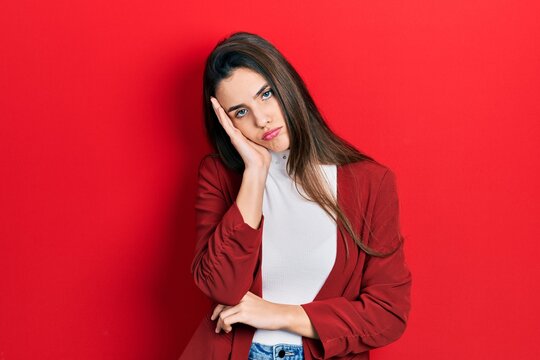 Young brunette teenager wearing business jacket thinking looking tired and bored with depression problems with crossed arms.