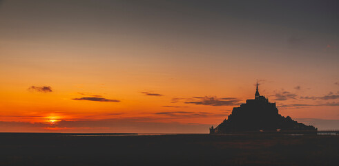 Panoramic view of the famous abbey of Le Mont Saint-Michel at sunset, Normandy, France