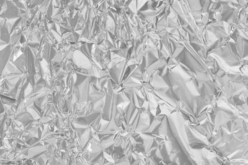 Shiny silver foil texture background, pattern of wrapping paper with crumpled and wavy.