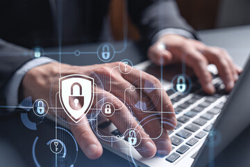 A programmer is typing a code on computer to protect a cyber security from hacker attacks and save...