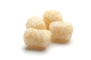 Close up of Cheese Potato Puff Snacks ball and buds, Popular Ready to eat crunchy and puffed snacks buds, cheesy salty pale-yellow color over white background