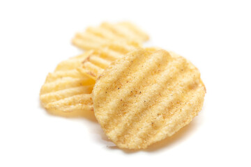 Close up of Wrinkled Wavy Potato Chips, Popular Ready to eat crunchy, salty pale-yellow color over white background