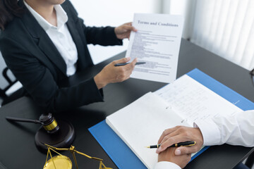 law,libra scale and hammer on the table, 2 lawyers are discussing about terms and condition, law matters determination