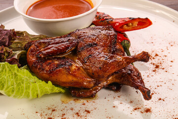 Roasted quail with tomato sauce