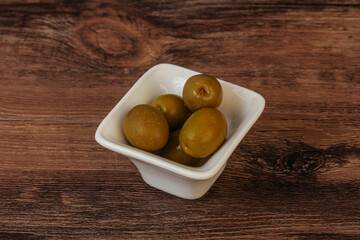 Green pickled olives in the bowl
