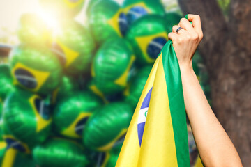 Man holding flag at street demonstration against corruption in Brazil. Concept democracy image with...