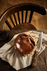 Basque burnt cheesecake serve with black coffee on drapery. San Sebastian cake. Trendy dessert, home cooking, local food, San Sebastian, Spain. New York style Cheese cake