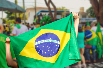 Man holding flag at street demonstration against corruption in Brazil. Concept democracy image with...