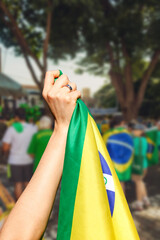 Man holding flag at street demonstration against corruption in Brazil. Concept democracy image with...