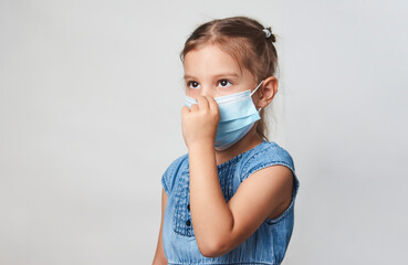 Little girl wearing face mask on a white background