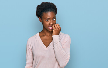 Young african american girl wearing casual clothes looking stressed and nervous with hands on mouth biting nails. anxiety problem.