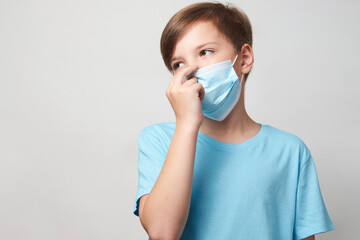 School boy with face mask on white background