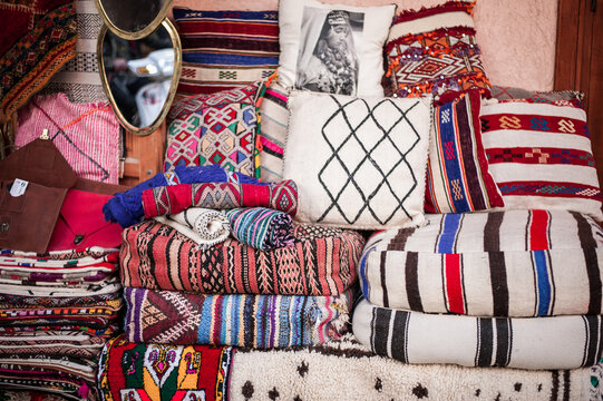 sale of traditional bright colored textiles and fabrics on the street market in the old town in the Middle East of Morocco