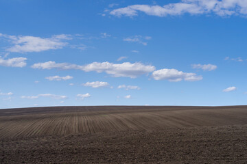 Fototapeta na wymiar Field ploughed in spring. Podilski Tovtry nature reserve in Podolia region, South-Western Ukraine