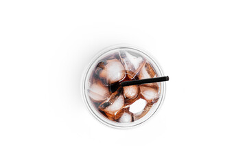 Soda with ice in a transparent plastic glass isolated on a white background.