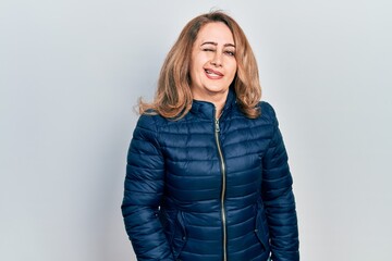 Middle age caucasian woman wearing casual clothes winking looking at the camera with sexy...
