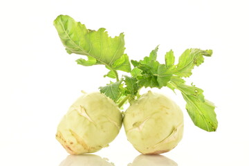 Two uncooked organic kohlrabi cabbage, close-up, isolated on white.