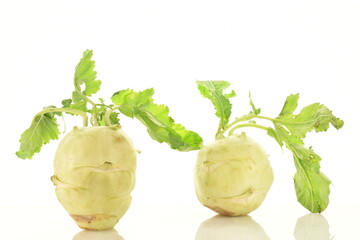 Two uncooked organic kohlrabi cabbage, close-up, isolated on white.