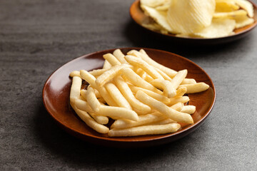 Potato chips and french fries snack in dish.