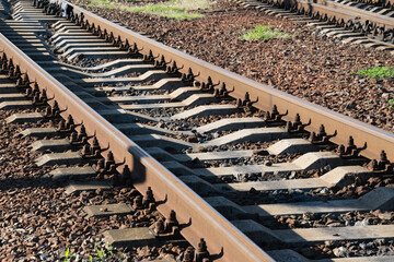 Railroad tracks close up on a sunny warm evening.