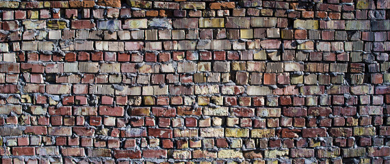 Empty old brick wall texture. Painted problem wall surfaces. Chic wide brick. Grange Red Stone Background. The shabby facade of the building with damaged plaster.