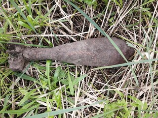 Rusty WWII (The Second World War) Artillery shell lying on the ground