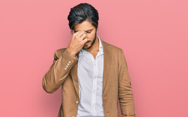 Young hispanic man wearing business clothes tired rubbing nose and eyes feeling fatigue and...