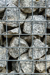 Small rocks or gravel, used for construction within a wire fence