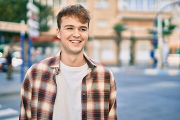 Fototapeta premium Young caucasian man smiling happy standing at the city.