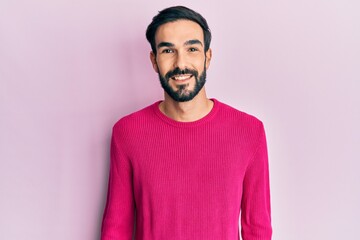 Young hispanic man wearing casual clothes with a happy and cool smile on face. lucky person.
