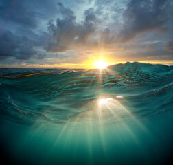 ocean in sunset light with Water line underwater sunrays
