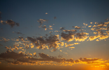 Beautiful sunset with scattered small clouds in the sky. Resource for replacement of skies.