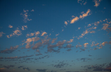 Beautiful sunset with scattered small clouds in the sky. Resource for replacement of skies.