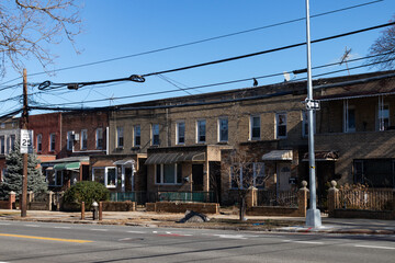Row of Old Brick Neighborhood Homes along an Empty Street and Sidewalk in Astoria Queens New York