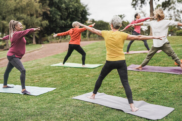 Multiracial people doing yoga with social distance for coronavirus outbreak at city park - Concept...