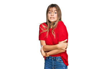 Teenager caucasian girl wearing casual red t shirt shaking and freezing for winter cold with sad and shock expression on face