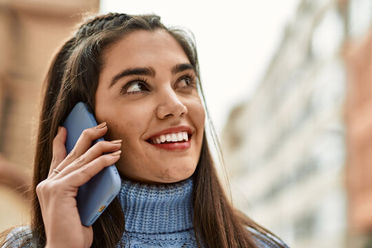 Young hispanic girl  smiling happy talking on the smartphone at the city