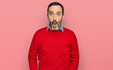 Middle age hispanic man wearing casual clothes afraid and shocked with surprise expression, fear and excited face.