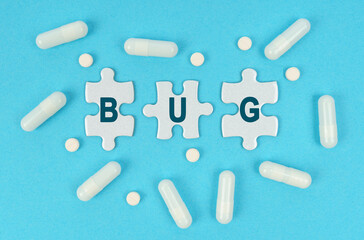 On a blue background, there are pills and puzzles with the inscription - BUG