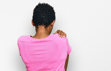 Young african american woman wearing casual clothes hugging oneself happy and positive from...
